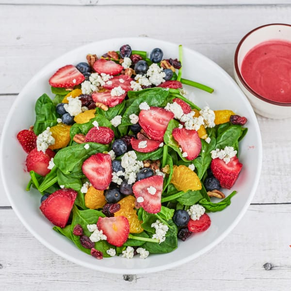 Humpty Dumpty Kitchen's vibrant spinach salad with strawberries, blueberries, oranges, and feta cheese.